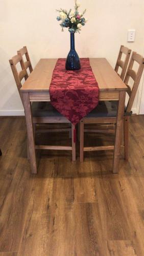 a wooden table with a vase with flowers on it at Elegant Design 2 Bed 2 Bath Apartment In Liverpool in Liverpool