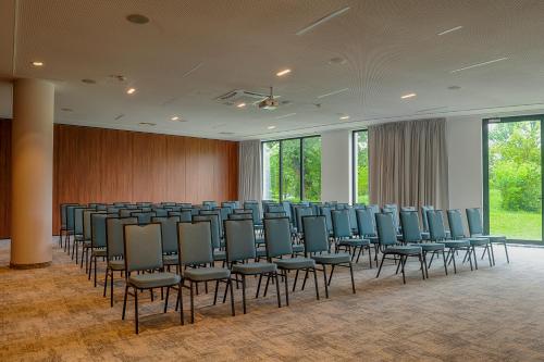 a conference room with a row of chairs and windows at Focus Hotel Premium Lublin in Lublin