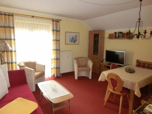 a living room with a couch and a table at Appartementhaus Margarita in Bad Füssing