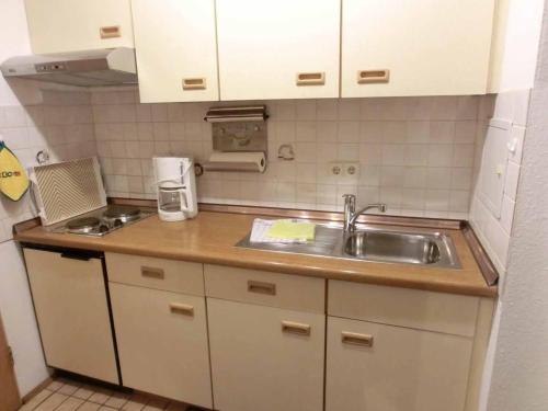 a small kitchen with a sink and a counter at Appartementhaus Margarita in Bad Füssing