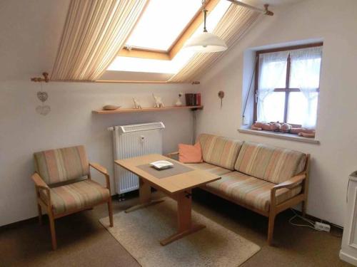 a living room with a couch and a table at Appartementhaus Margarita in Bad Füssing
