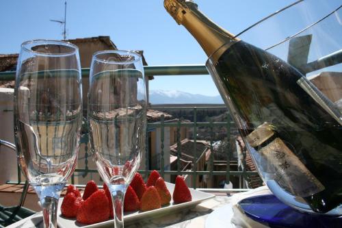 
a glass of wine sitting on top of a table at Hotel Spa La Casa Mudéjar in Segovia
