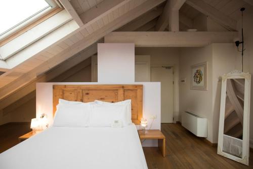 a bedroom with a large bed with white pillows at Art Hotel Varese in Varese