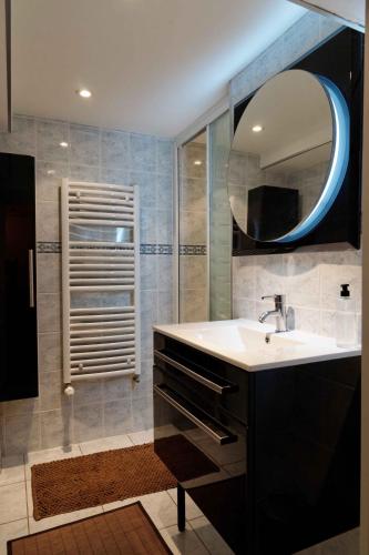 un baño con lavabo y espejo en Chambres d'hotes à Autun, en Autun