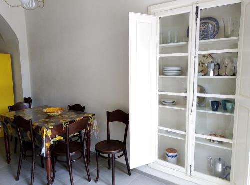 a dining room with a table and a glass cabinet at L'OZioRinco Apartments in Florence
