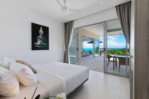 a bedroom with a bed and a view of the ocean at Single Level BEACHSIDE VILLA - BB2 - at BAYSIDE LUXURY VILLAS Samrong Bay Beach, 3 BED 4 BATH, SEA and SUNSET VIEWS, only 200m walk to the Beach in Bang Rak Beach