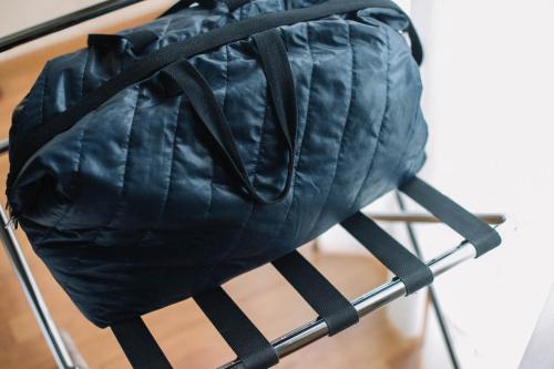 a black bag sitting on top of a chair at Lido Hotel in Katerini