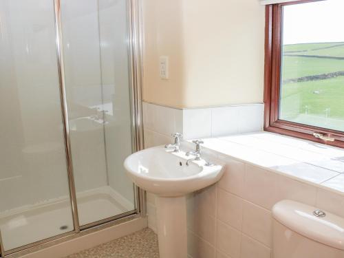 a bathroom with a sink and a shower at The Barn in Skipton