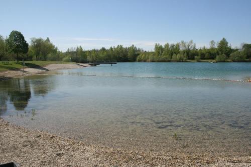 a lake with a dock in the middle of it at Privatzimmer und Ferienwohnungen Leeb in Persenbeug-Gottsdorf