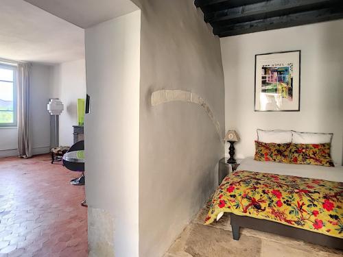 a bedroom with a bed in the corner of a room at La vie de chateau in Grignan