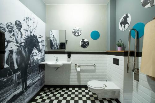 a bathroom with a toilet and a sink at Salio Equisport Resort in Stryków