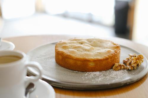 a piece of cake on a plate next to a cup of coffee at Nira Alpina in Silvaplana