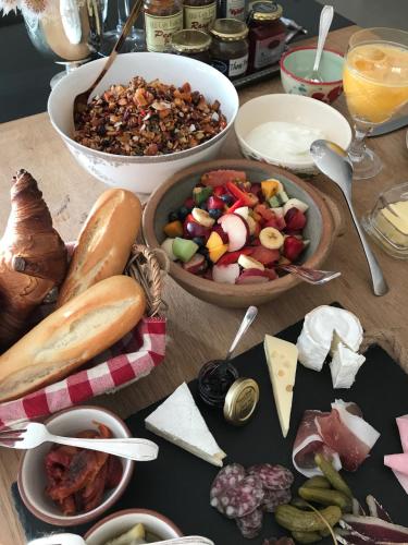 a table with a bunch of different types of food at Residence William French in Simonʼs Town