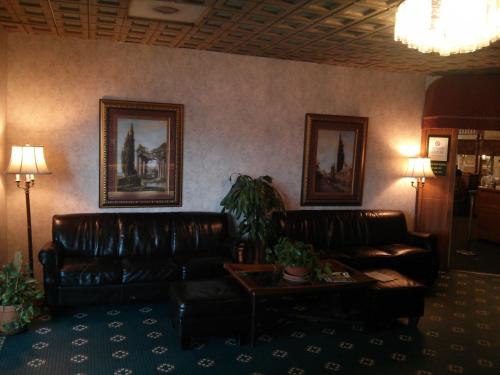 a living room with two leather couches and a table at Motel 6-Florence, SC in Florence