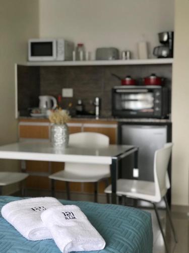 a kitchen with a table with two towels on it at ILLIA 121 APART HOTEL in Neuquén