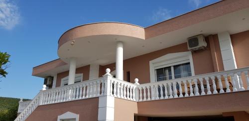 a house with a balcony on the side of it at Villa Anastasia Ksamil in Ksamil