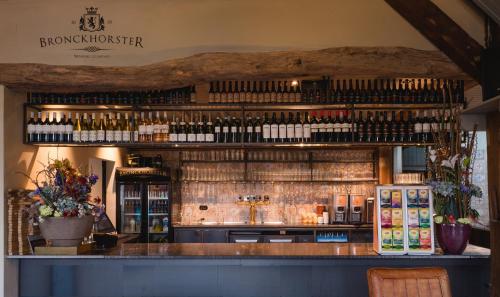 a bar with lots of bottles of wine at Herberg de Gouden Leeuw in Bronkhorst
