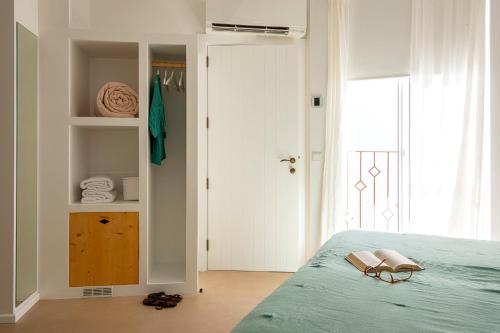 a bedroom with a bed and a door to a closet at Noualt in Ferreries