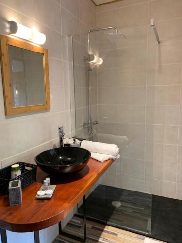a bathroom with a black sink and a shower at La Ferme de Kerraoul in Combrit