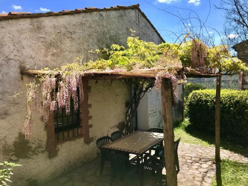 a table and chairs in front of a building with flowers at Agriturismo San Ottaviano in Monterotondo