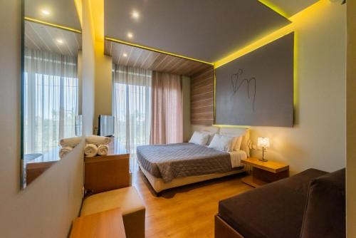 a hotel room with a bed and a couch at Kleopatra Inn in Messini