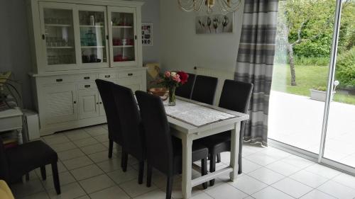 a kitchen with a dining room table and chairs at Le Hameau du moulin a vent in Saint-Avertin