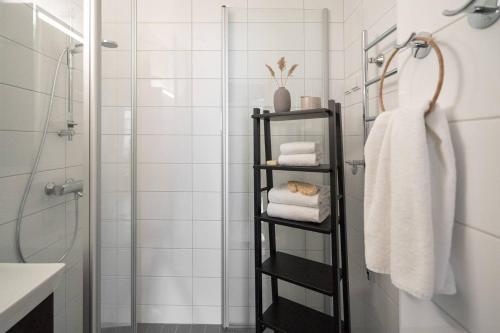 a bathroom with a black towel rack with towels at Roost Kristianinkatu 9 C in Helsinki