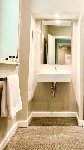 a bathroom with a sink and a mirror at Bue Nero Suites Verona in Verona