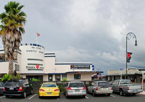 a group of cars parked in a parking lot in front of a building at Essex Arms in Huntly