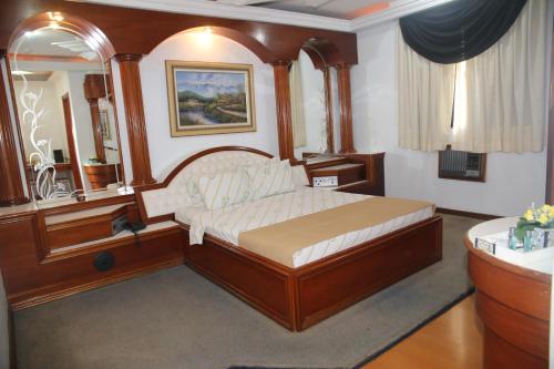 a bedroom with a large wooden bed in a room at Maison Florense Hotel in Sao Paulo