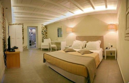 a bedroom with a large bed in a room at Oikies Small Elegant Houses in Mytilini
