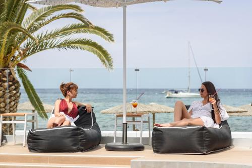 two women sitting in bean bags on the beach at Mare Boutique in Georgioupolis