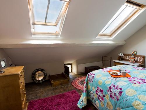 a bedroom with a bed and two skylights at Little Hawthorn in Menai Bridge