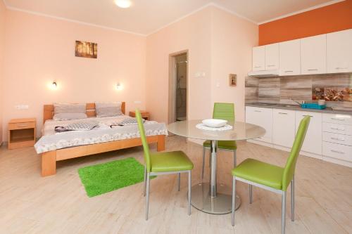 a bedroom with a bed and a table and chairs at Apartmani Lea in Starigrad