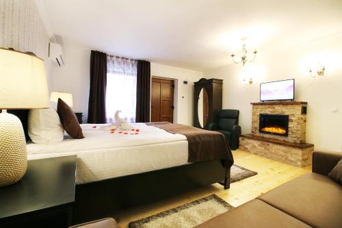 a hotel room with a bed and a fireplace at Select House in Sibiu