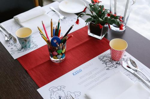 a table with pens and pencils on a table at Nira Alpina in Silvaplana