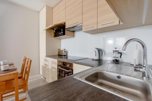 a kitchen with a sink and a counter top at Resort Apartamenty Klifowa Rewal 23 in Rewal