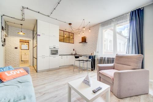 a living room with a couch and a table at Rint - Centrum Lipowa Street in Białystok