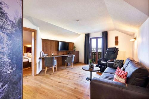 a living room with a couch and a table at Schätzlhof OHG in Ruderting