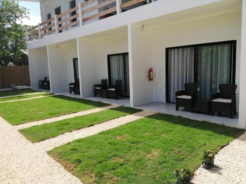 a view of a house with green grass at Christelle Inn in Panglao