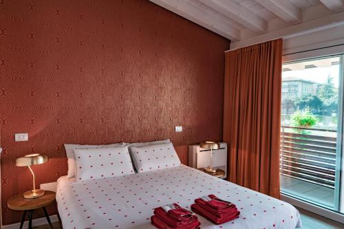 a bedroom with a bed with two red towels on it at Alla Riva in Verona