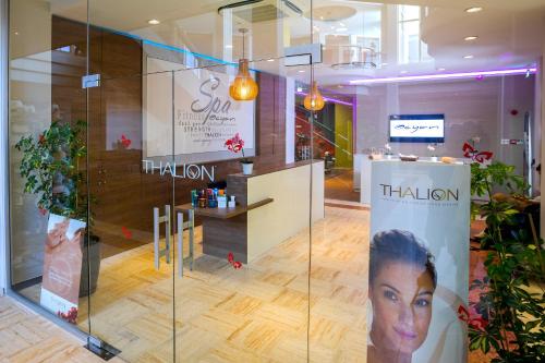 a salon with a glass wall in a room at Leonardo Laura Beach & Splash Resort in Paphos City