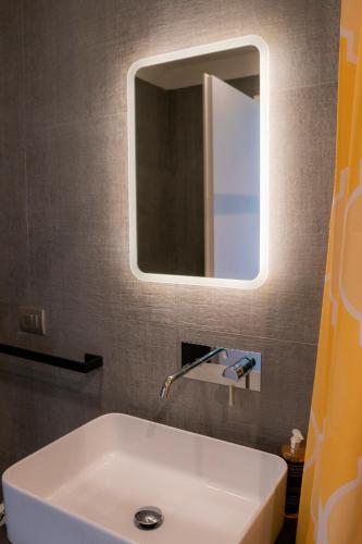 a bathroom with a white sink and a mirror at Alla Riva in Verona