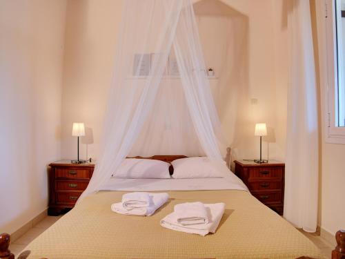 a bedroom with a bed with two towels on it at Guesthouse Agia Triada in Koroni