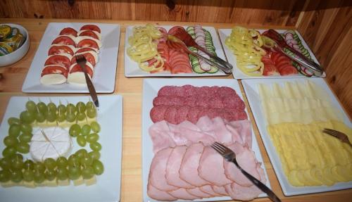 a table with many different types of food on plates at Penzion Sabina in Vernár
