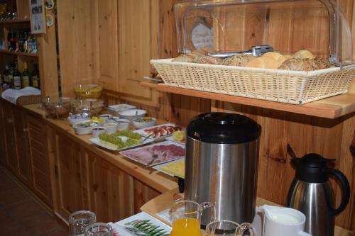 a kitchen with a buffet with bread and food at Penzion Sabina in Vernár