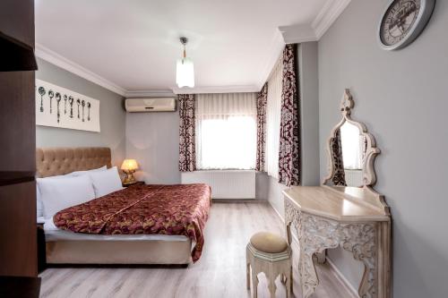 a hotel room with a bed and a desk at Masal Apart in Istanbul