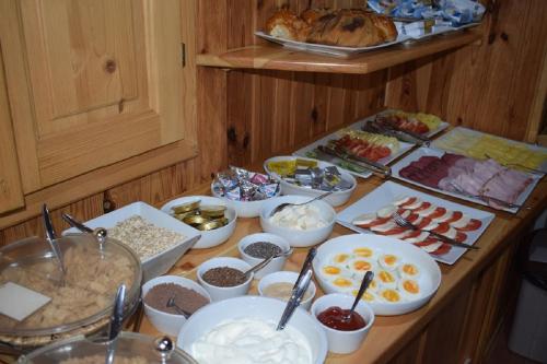 a table with many different types of food on it at Penzion Sabina in Vernár