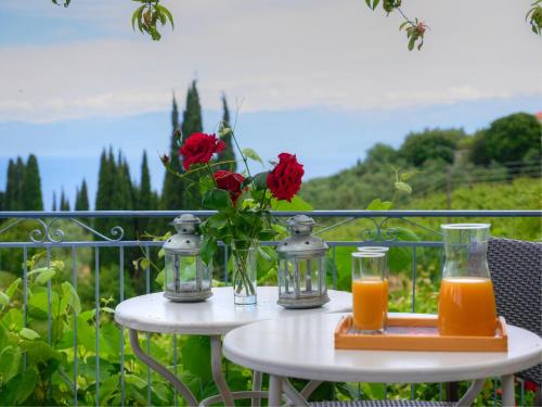 a table with two glasses of orange juice and flowers at Guesthouse Agia Triada in Koroni