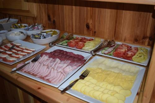 a buffet with different types of food on a table at Penzion Sabina in Vernár
